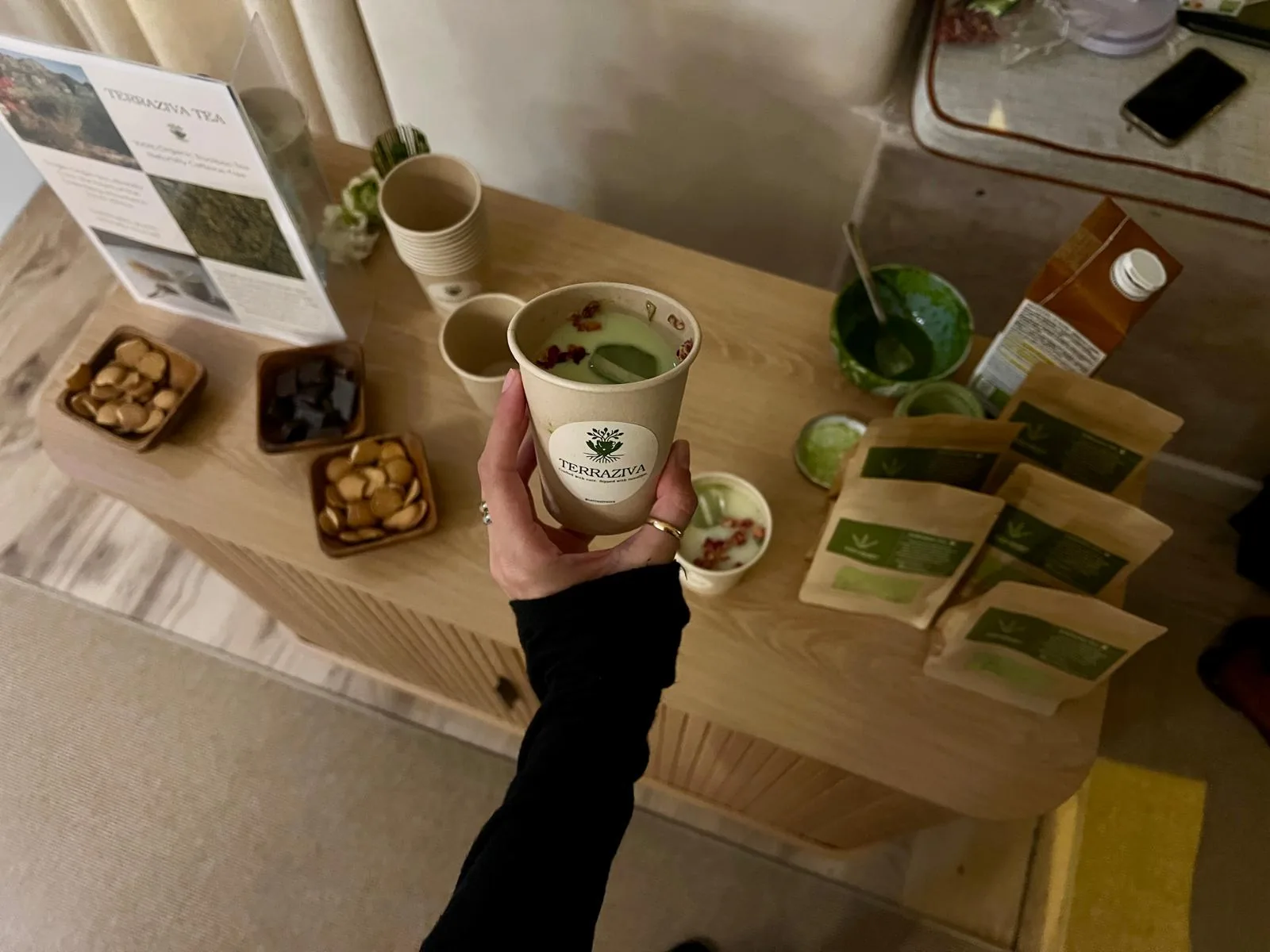 TerraZiva cup held above a tasting table