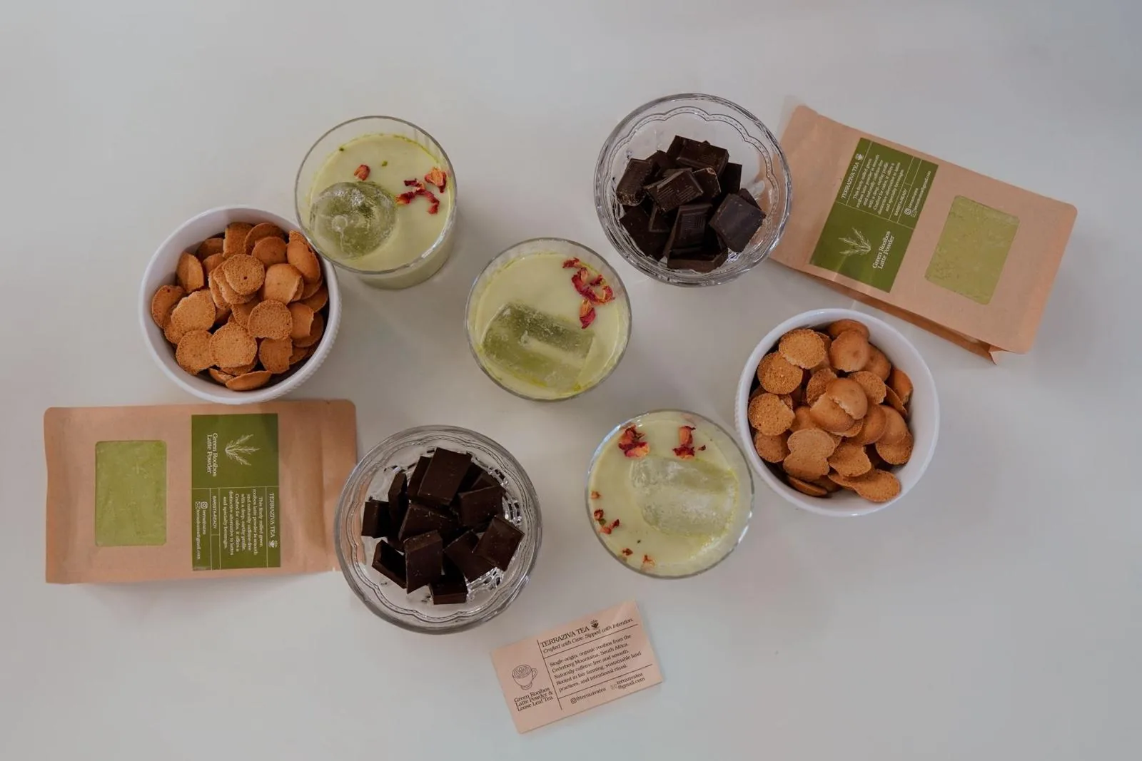 Flatlay of lattes, pouches, and tasting bites